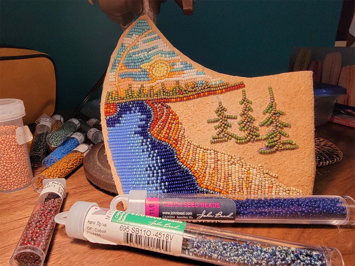 One half of the beaded face mask completed